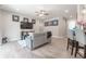 Open concept living room with TV, gray couch, and hardwood floors at 5525 Barma St, Orlando, FL 32807