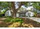 Charming light blue house with a large tree in front at 5525 Barma St, Orlando, FL 32807