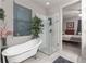 Bathroom with freestanding tub, walk-in shower, and window at 5525 Barma St, Orlando, FL 32807