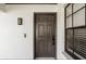 Inviting entryway with a dark brown door and a sleek modern light fixture at 10544 Wyndcliff Dr, Orlando, FL 32817