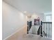 Upstairs hallway with neutral walls, carpeting, and metal railing at 1849 Cayman Cove Cir, Saint Cloud, FL 34772