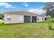 Well maintained house exterior with a screened patio and backyard at 429 Tamarind Parke Ln, Kissimmee, FL 34758