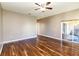 Bright living room featuring hardwood floors and sliding glass doors leading to a patio at 429 Tamarind Parke Ln, Kissimmee, FL 34758