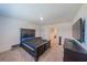 Primary bedroom with dark wood bed frame and TV at 1714 Wynford Cir, Tavares, FL 32778
