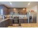 Modern kitchen with granite countertops and stainless steel appliances at 1714 Wynford Cir, Tavares, FL 32778