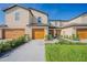 Two-story townhome with double garage and walkway at 1714 Wynford Cir, Tavares, FL 32778