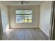 Bright bedroom with wood-look floors and a large window at 4105 Tropical Isle Blvd # 238, Kissimmee, FL 34741