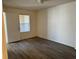 Second bedroom with wood-look floors and large window at 4105 Tropical Isle Blvd # 238, Kissimmee, FL 34741