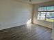 Bright bedroom featuring wood-look flooring and large window at 4105 Tropical Isle Blvd # 238, Kissimmee, FL 34741