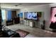 Spacious living room featuring a large TV and comfortable seating at 1149 Holden Ave, Orlando, FL 32839