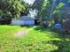 Large backyard with lush green grass and mature trees at 1149 Holden Ave, Orlando, FL 32839