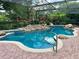 Relaxing screened-in pool with waterfall feature and brick pavers at 3336 Edgecliffe Dr, Orlando, FL 32806