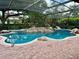 Inviting kidney-shaped pool with a waterfall feature and screened enclosure at 3336 Edgecliffe Dr, Orlando, FL 32806