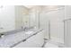Modern bathroom with granite countertop and walk-in shower at 7944 Formosa Valley Pl, Kissimmee, FL 34747