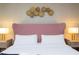 Main bedroom with a pink upholstered headboard and a neutral color scheme at 7944 Formosa Valley Pl, Kissimmee, FL 34747