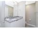 Bathroom with granite countertop, double vanity, and mirror at 7944 Formosa Valley Pl, Kissimmee, FL 34747