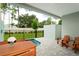 Relaxing patio with private pool, wooden chairs, and a wooden table at 7944 Formosa Valley Pl, Kissimmee, FL 34747