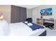 Bedroom with king-size bed, seating area, and a large TV at 7944 Formosa Valley Pl, Kissimmee, FL 34747