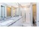 Bathroom with granite countertops, a large shower, and modern fixtures at 7944 Formosa Valley Pl, Kissimmee, FL 34747