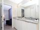 Bathroom featuring granite countertops, double sinks and modern design at 7944 Formosa Valley Pl, Kissimmee, FL 34747