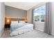 Spacious bedroom with a king-size bed, large window, and modern decor at 7944 Formosa Valley Pl, Kissimmee, FL 34747