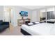 Bedroom with king-size bed, en-suite bathroom access, and TV at 7944 Formosa Valley Pl, Kissimmee, FL 34747