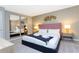 Main bedroom with a pink upholstered bed and large mirrors at 7944 Formosa Valley Pl, Kissimmee, FL 34747