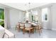 Elegant dining room with modern light fixture and seating for six at 7944 Formosa Valley Pl, Kissimmee, FL 34747