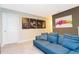 Game room with blue couch and Star Wars artwork at 7944 Formosa Valley Pl, Kissimmee, FL 34747
