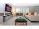 Living area with comfy seating and large screen TV at 7944 Formosa Valley Pl, Kissimmee, FL 34747