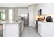 Modern kitchen with stainless steel appliances and granite island at 7944 Formosa Valley Pl, Kissimmee, FL 34747