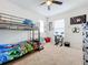 Spacious bedroom with a bunk bed, desk, and play area at 1526 White Hawk Way, Groveland, FL 34736