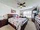 Spacious bedroom with large bed, dresser, and workspace at 1526 White Hawk Way, Groveland, FL 34736