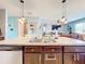Kitchen island with a double sink and dishwasher, open to living room at 1526 White Hawk Way, Groveland, FL 34736