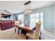 Bright dining area with farmhouse style table and sliding glass doors at 1526 White Hawk Way, Groveland, FL 34736