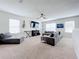 Open bonus room, featuring a sectional sofa and entertainment center at 1526 White Hawk Way, Groveland, FL 34736