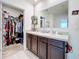 Bathroom with double vanity and walk-in closet at 1526 White Hawk Way, Groveland, FL 34736
