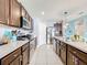 Modern kitchen with stainless steel appliances and dark wood cabinets at 1526 White Hawk Way, Groveland, FL 34736