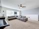 Relaxing bonus room with sectional sofa and large windows at 1526 White Hawk Way, Groveland, FL 34736