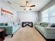 Living room with teal sofas, ceiling fan, and neutral walls at 1526 White Hawk Way, Groveland, FL 34736