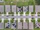 Aerial view of neighborhood street with houses and solar panels at 1526 White Hawk Way, Groveland, FL 34736