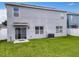 Large backyard with grassy area, fence and patio at 1526 White Hawk Way, Groveland, FL 34736