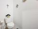 Small bathroom with toilet and decorative wall hangings at 1526 White Hawk Way, Groveland, FL 34736