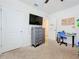 Well-lit bedroom with a dresser, desk and closet at 1526 White Hawk Way, Groveland, FL 34736