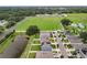 Aerial view of neighborhood with pond and houses with solar panels at 1526 White Hawk Way, Groveland, FL 34736