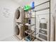 Laundry room with washer, dryer, and shelving at 1526 White Hawk Way, Groveland, FL 34736