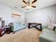 Living room with teal sofas, ceiling fan, and neutral walls at 1526 White Hawk Way, Groveland, FL 34736