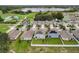 Aerial view of neighborhood with lake and houses with solar panels at 1526 White Hawk Way, Groveland, FL 34736