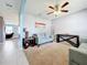 Living room with teal sofas, ceiling fan, and neutral walls at 1526 White Hawk Way, Groveland, FL 34736