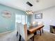 Charming dining room with a rustic wooden table and pendant lighting at 1526 White Hawk Way, Groveland, FL 34736